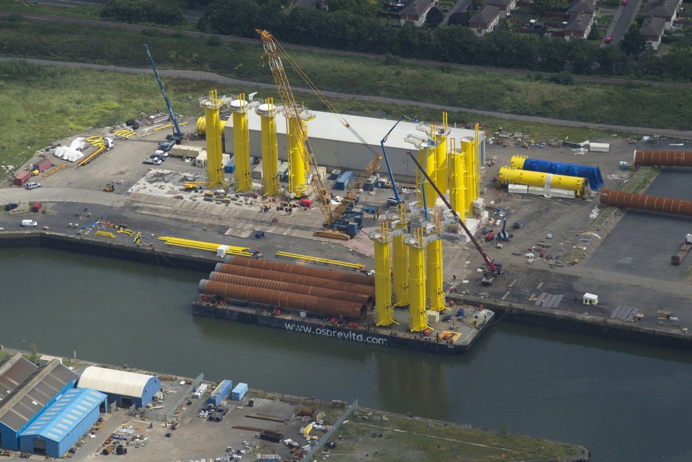 Monopiles and transition pieces laid out on the TAG quayside
